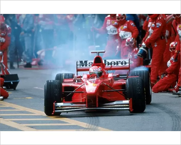 Formula One World Championship: Eddie Irvine Ferrari F300 leaves the pits