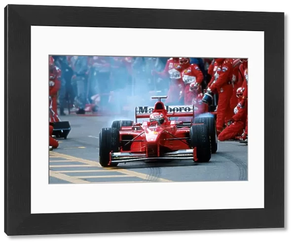 Formula One World Championship: Eddie Irvine Ferrari F300 leaves the pits