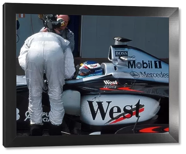 Formula One World Championship: David Coulthard McLaren who finished 2nd, chats to race winner Mika Hakkinen McLaren Mercedes MP4  /  13 in parc ferme
