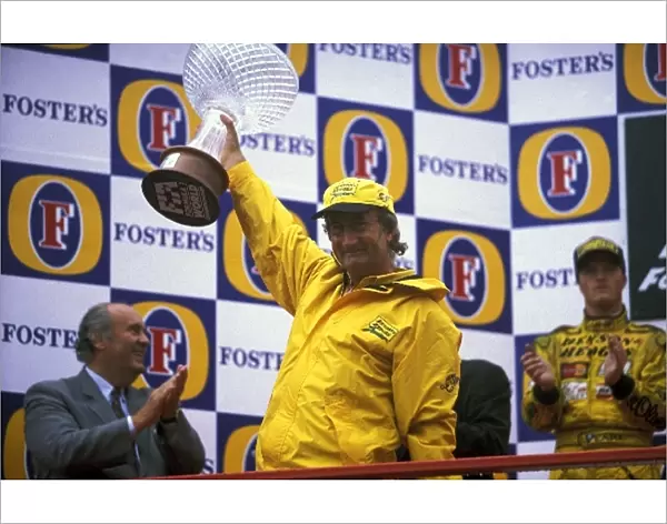 Formula One World Championship: Eddie Jordan Jordan team owner celebrates the teams first win on the podium