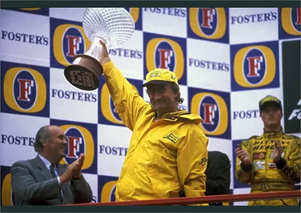 Formula One World Championship: Eddie Jordan Jordan team owner celebrates the teams first win on the podium