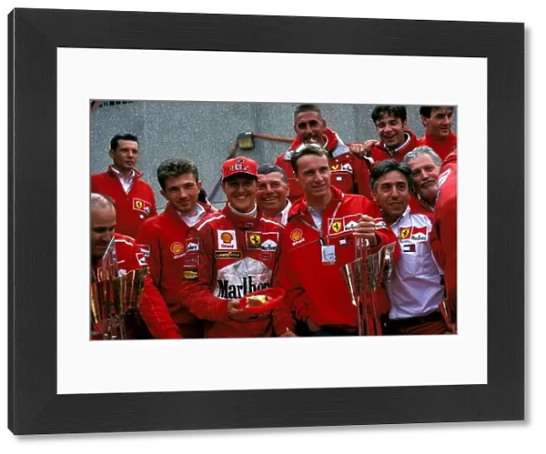 Formula One World Championship: Michael Schumacher & team mate Eddie Irvine. Ferrari team prinicpal Franco Gozzi can be seen second from right