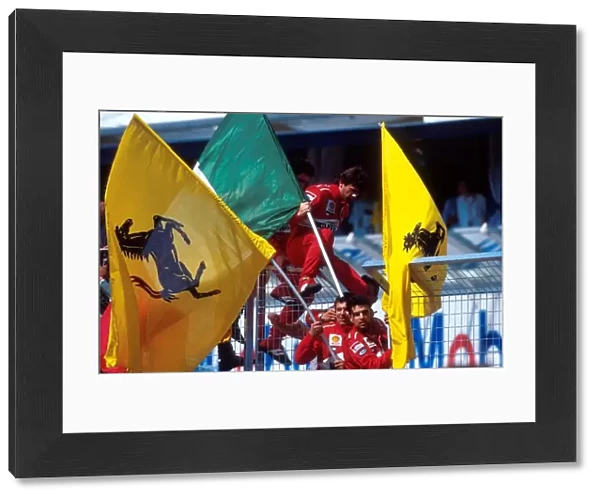 Formula One World Championship: Ferrari mechanics with flags celebrate their victory