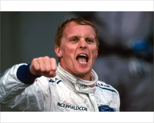 Formula One World Championship: Race winner Johnny Herbert, Stewart Grand Prix, celebrates on the podium