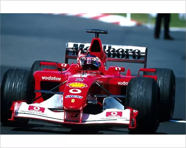 Formula One World Championship: Race winner Rubens Barrichello Ferrari F2002 waves to the crowd in celebration