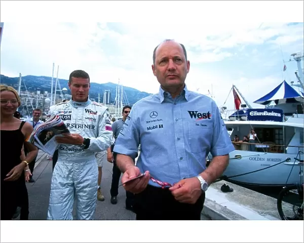 Formula One World Championship: McLaren team owner Ron Dennis and McLaren driver David Coulthard make their way to the paddock