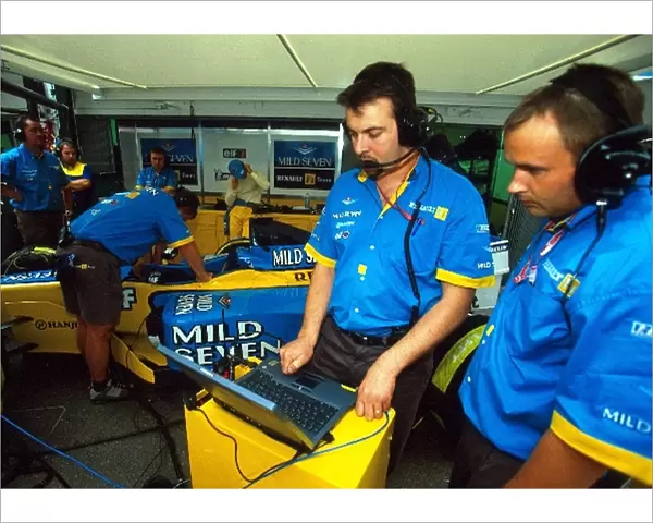 Formula One World Championship: The Renault team work on set-up of the R202