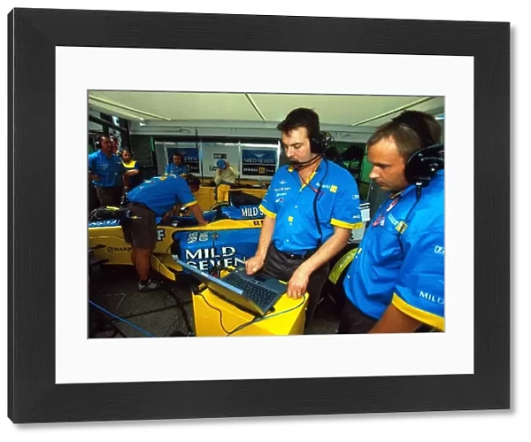 Formula One World Championship: The Renault team work on set-up of the R202