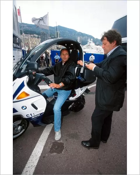 Formula One World Championship: Gerhard Berger BMW Competitions Director aboard a BMW C1: 200 moped talks with Norbert Haug Mercedes Motorsport