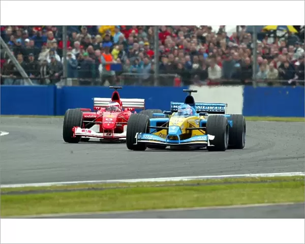 Formula One World Championship: Jenson Button Renault R202 is chased by a fast recovering Rubens Barrichello Ferrari F2002 who finished second