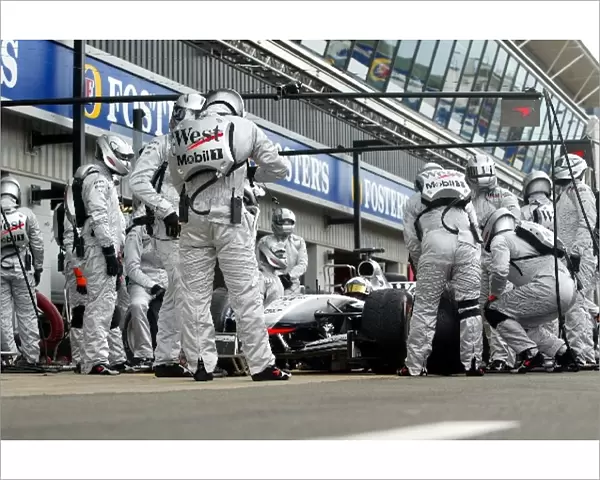 Formula One World Championship: McLaren practice the pitstops on the MP4  /  17 using their new temperature controlled team race suits
