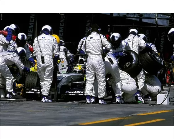 Formula One World Championship: Ralf Schumacher, BMW Williams FW24, takes a regular pit stop but was slowed when the mechanic had problems changing