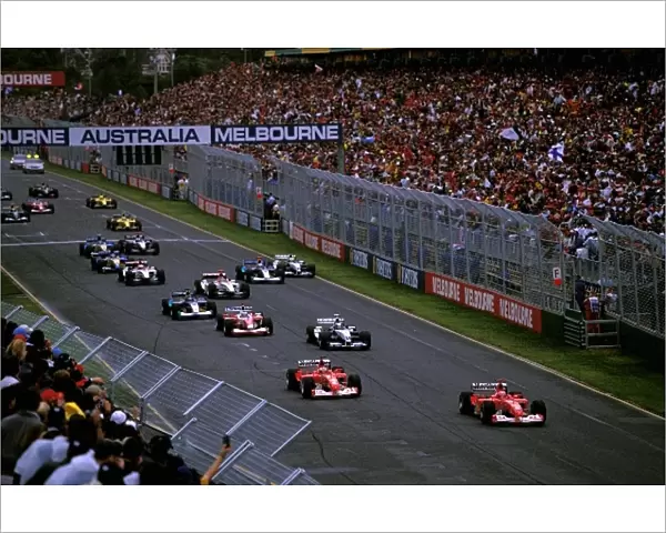 Formula One World Championship: Michael Schumacher, Ferrari F2002, leads the field away from pole position at the start of the race