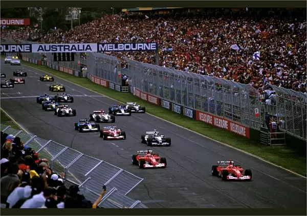 Formula One World Championship: Michael Schumacher, Ferrari F2002, leads the field away from pole position at the start of the race
