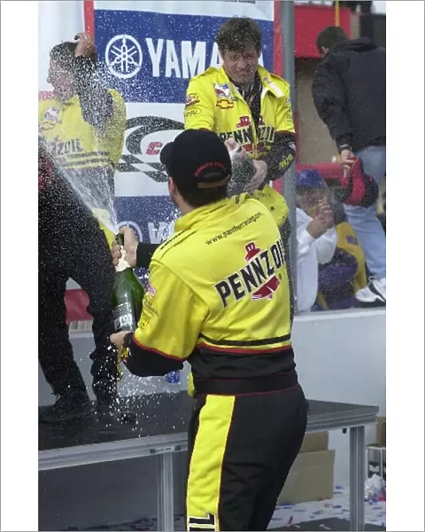 Race winner Sam Hornish, (USA), has a champagne battle with his crew after winning the Yamaha 400