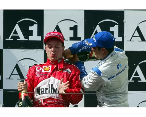 Formula One World Championship: Moral victor Rubens Barrichello Ferrari is showered in champagne bythird placed Juan Pablo Montoya Williams
