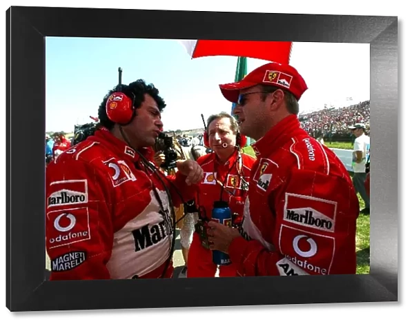 Formula One World Championship: Gabriele Delli Colli Ferrari Race Engineer talks with Rubens Barrichello Ferrari on the grid watched by Jean