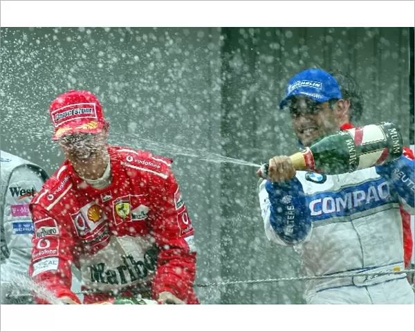 Formula One World Championship: Second placed Juan Pablo Montoya Williams and winner Michael Schumacher Ferrari spray the champagne
