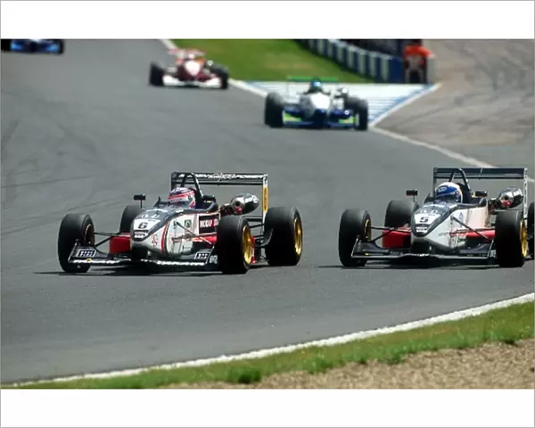 British Formula Three Championship: Winner of race two Takuma Sato Carlin Motororsport Dallara-Mugen battles for position with team mate Anthony