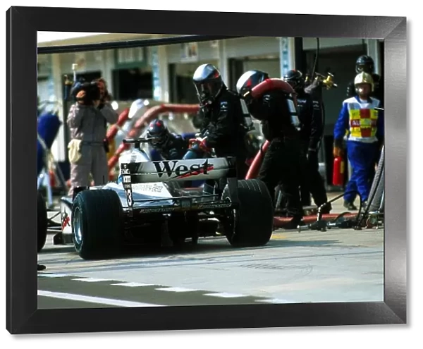 Formula One World Championship: Fifth place finisher Mika Hakkinen McLaren MP4  /  16 makes a mid race pit stop