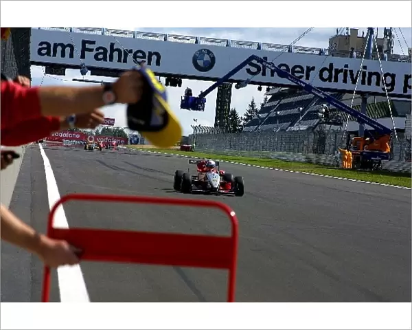 German Formula Three Championship: Race winner Markus Winkelhock crosses the finishing line to the delight of his team