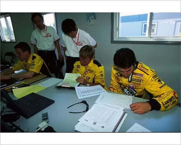 Formula One World Championship: Honda technicians, David Brown and Ricardo Zonta examine telemetry read outs