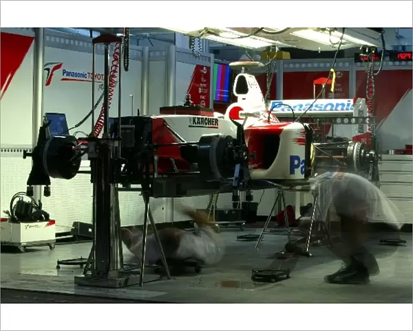 Formula One World Championship: Toyota mechanics work on the cars in the garage into the night