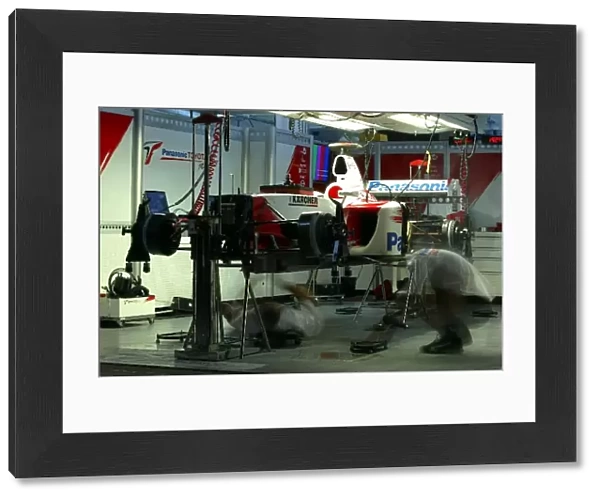 Formula One World Championship: Toyota mechanics work on the cars in the garage into the night