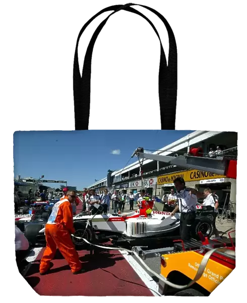Formula One World Championship: The car of Anthony Davidson BAR Honda 006 is returned to the pits after his practice crash
