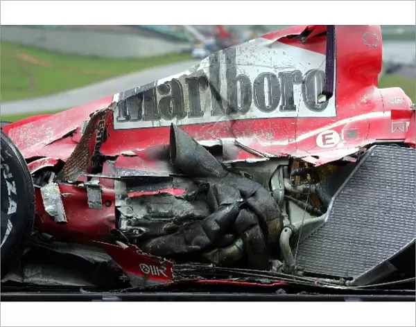 Formula One World Championship: The damaged car of Michael Schumacher Ferrari F2004 is loaded onto a truck after a practice crash
