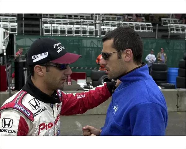 Tony Kanaan and Dario Franchitti talk it over in the pits prior to Saturday morning practice for the G. I. Joes 200. Portland International Raceway, Portland, Or. 16 June, 2002