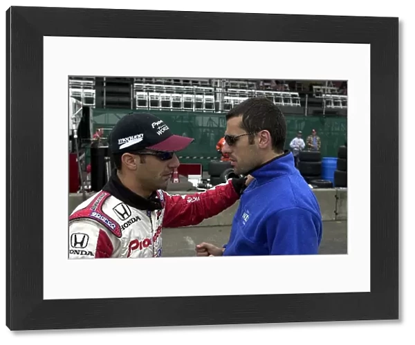 Tony Kanaan and Dario Franchitti talk it over in the pits prior to Saturday morning practice for the G. I. Joes 200. Portland International Raceway, Portland, Or. 16 June, 2002