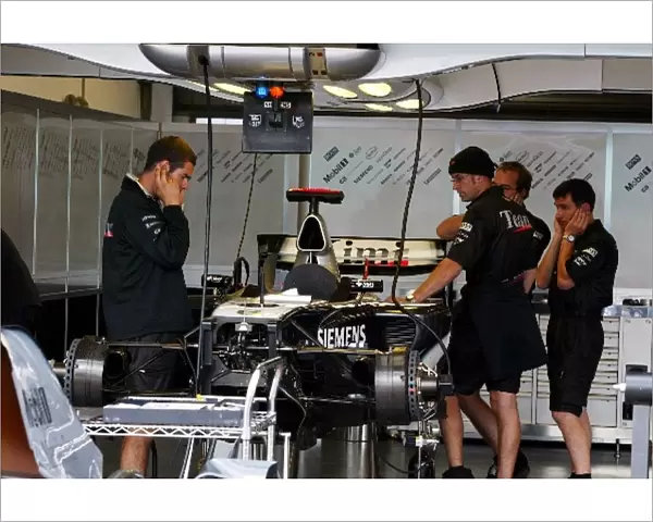 Formula One World Championship: McLaren prepare the MP4  /  19B in the pits