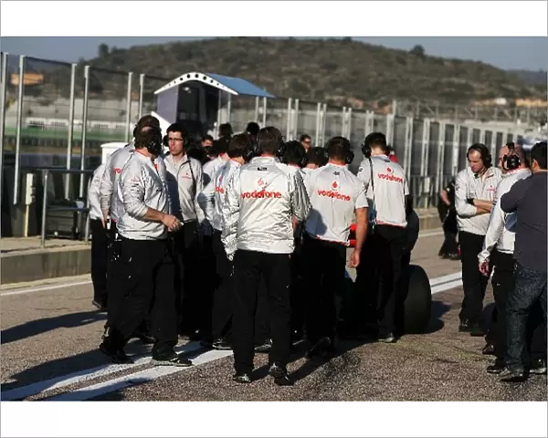 Formula One World Championship: McLaren mechanics swarm around Lewis Hamilton McLaren MP4  /  25 in the pits