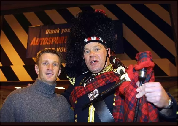 Autosport International Show: Allan McNish Toyota with his bagpipe player