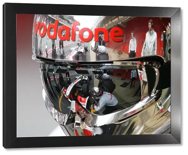 Formula One World Championship: A reflection of Lewis Hamilton McLaren MP4  /  25 in a mechanics helmet