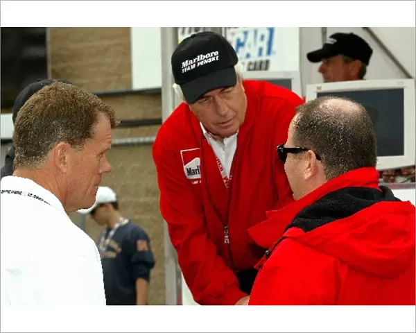 (L to R): Team owners Tom Kelley, Roger Penske, and Chip Ganassi hold an impromptu meeting