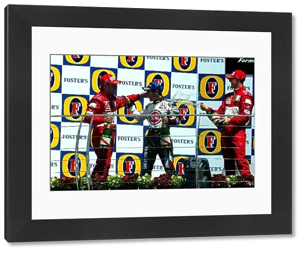 Formula One World Championship: The podium finishers: Rubens Barrichello Ferrari, Michael Schumacher Ferrari and Takuma Sato BAR