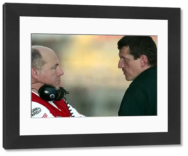 Formula One Testing: Guenther Steiner, right, Jaguar Technical Director chats with a Toyota engineer