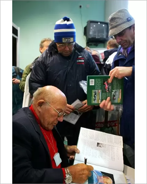 Aintree Festival of Motorsport: Sir Stirling Moss OBE signs autographs for the fans