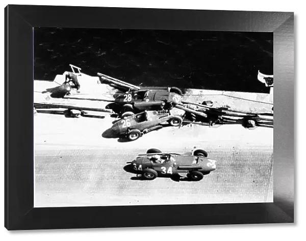 1957 Monaco Grand Prix. Monte Carlo, Monaco. 19 May 1957. Giorgio Scarlatti, Maserati 250F, retired, passes the crashed cars of Peter Collins, Lancia-Ferrari D50, and Mike Hawthorn, Lancia-Ferrari D50, action, accident