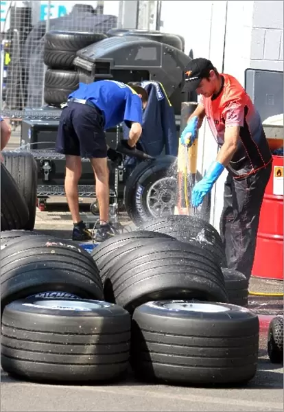Formula One World Championship: McLaren and Michelin personnel wash tyres