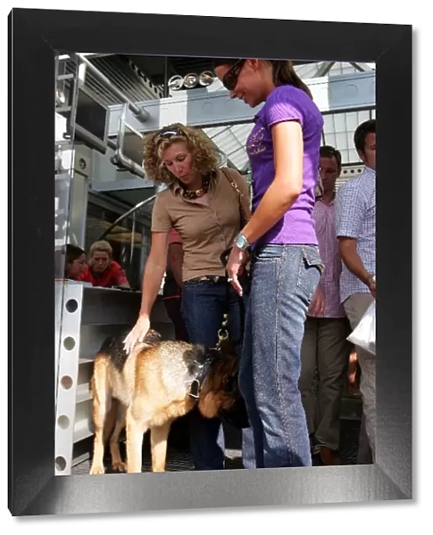 Formula One World Championship: Jenni Dahlman, right, wife of Kimi Raikkonen McLaren with dog