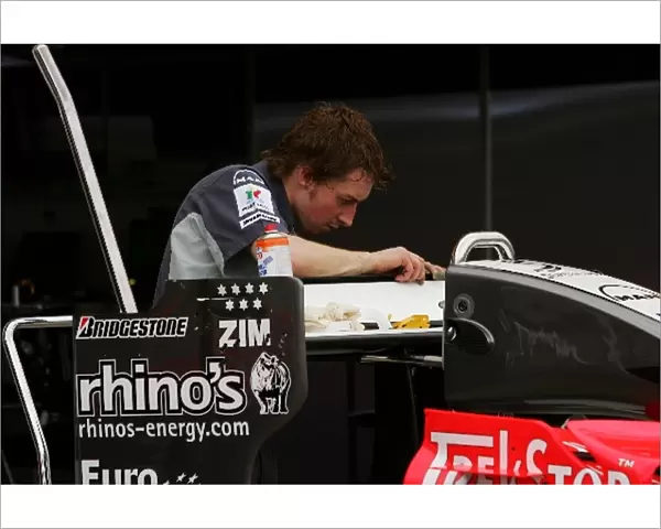 Formula One World Championship: MF1 mechanic works on the rear wing of the MF1 M16