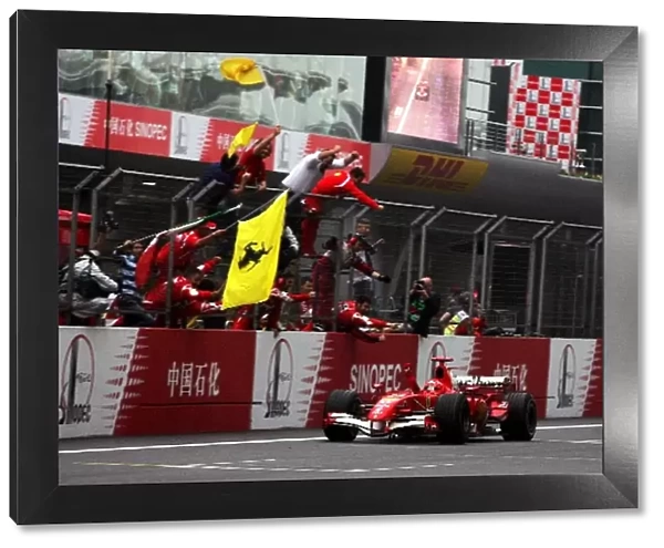 Formula One World Championship: Race winner Michael Schumacher Ferrari 248 F1 celebrates as he finishes the race