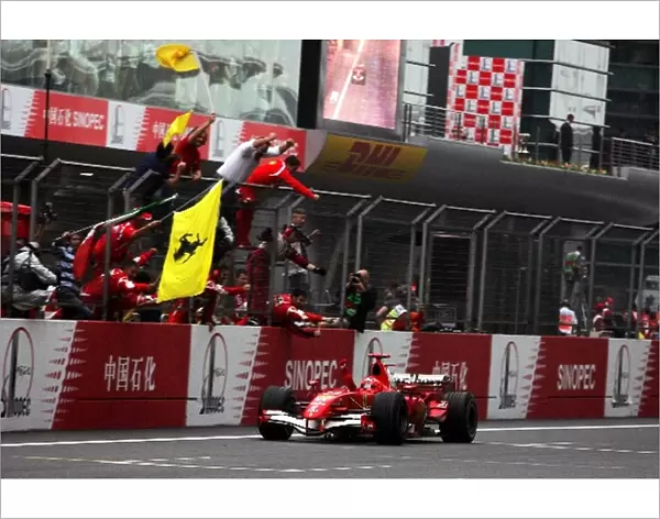 Formula One World Championship: Race winner Michael Schumacher Ferrari 248 F1 celebrates as he finishes the race