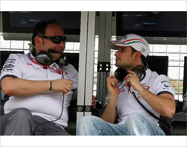 Formula One World Championship: Colin Kolles Force India F1 Team Principal talks with Vitantonio Liuzzi Force India F1 Third Driver