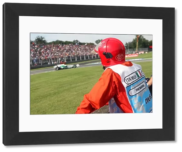 Formula One World Championship: A Fire Marshal watches Rubens Barrichello Honda RA108