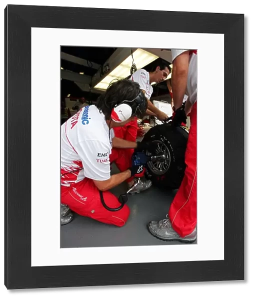 Formula One World Championship: Toyota mechanic puts a wheel on the Toyota TF108
