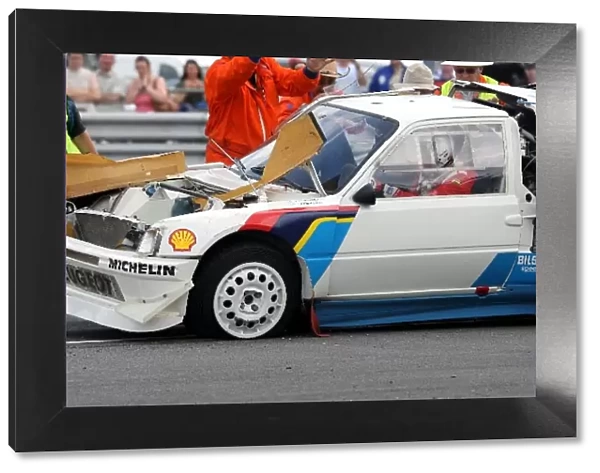 Silverstone Classic: Peugeot 205 T16 Rally Car is rolled back onto its wheels after rolling during a demonstration